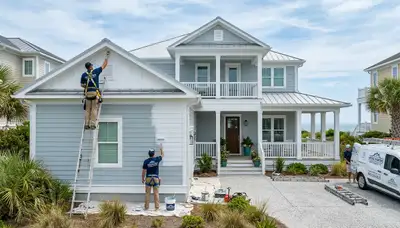 Professional house painters in Wilmington NC applying exterior paint to a coastal home façade