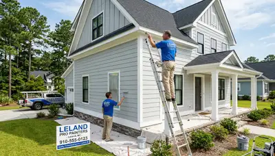 Professional house painters working on exterior home repaint in Wilmington NC