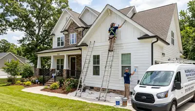 Professional house painters working on residential exterior in Wilmington, NC